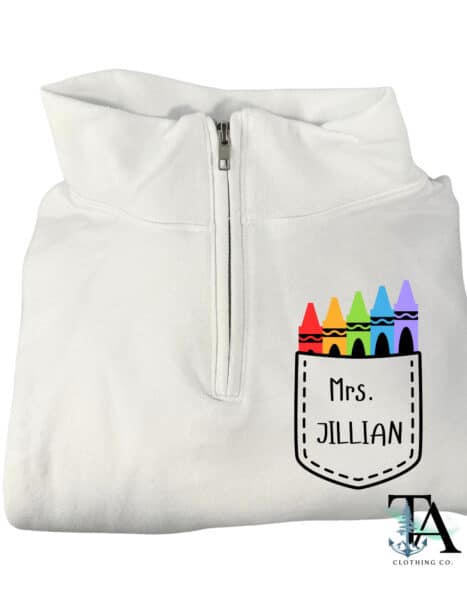 White quarter zipped sweatshirt with a pocket chest logo and colorful crayon designs. Customized with name or text for gifts for teachers, ECE and daycare workers.