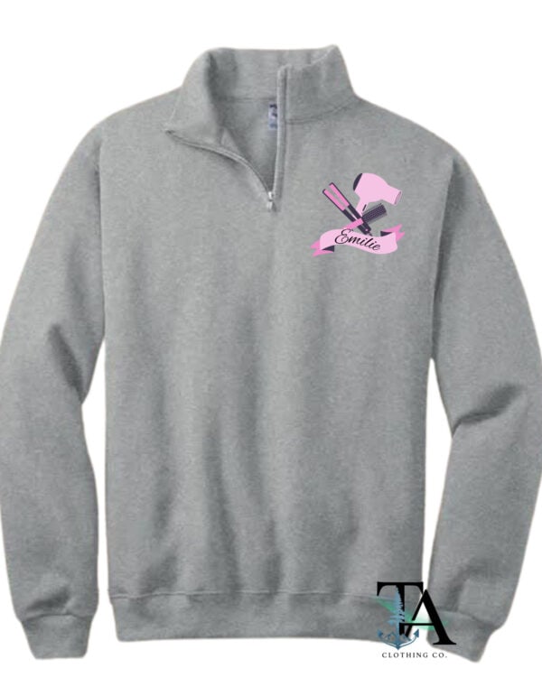 Quarter zip sweatshirt created in New Brunswick Canada featuring a chest patch for custom name hairdresser logo. Logo contains a hairbrush, a hairdryer and a straightener in pink. For gifting hairdressers, hairdresser graduates and hair enthusiasts.